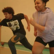 Young teens engaging in a cardio activity at Springfield YMCA’s childcare center, fostering a healthy lifestyle for youth.