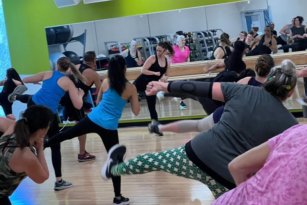 A group of adults participating in a fitness class at the Springfield YMCA, promoting health and well-being.