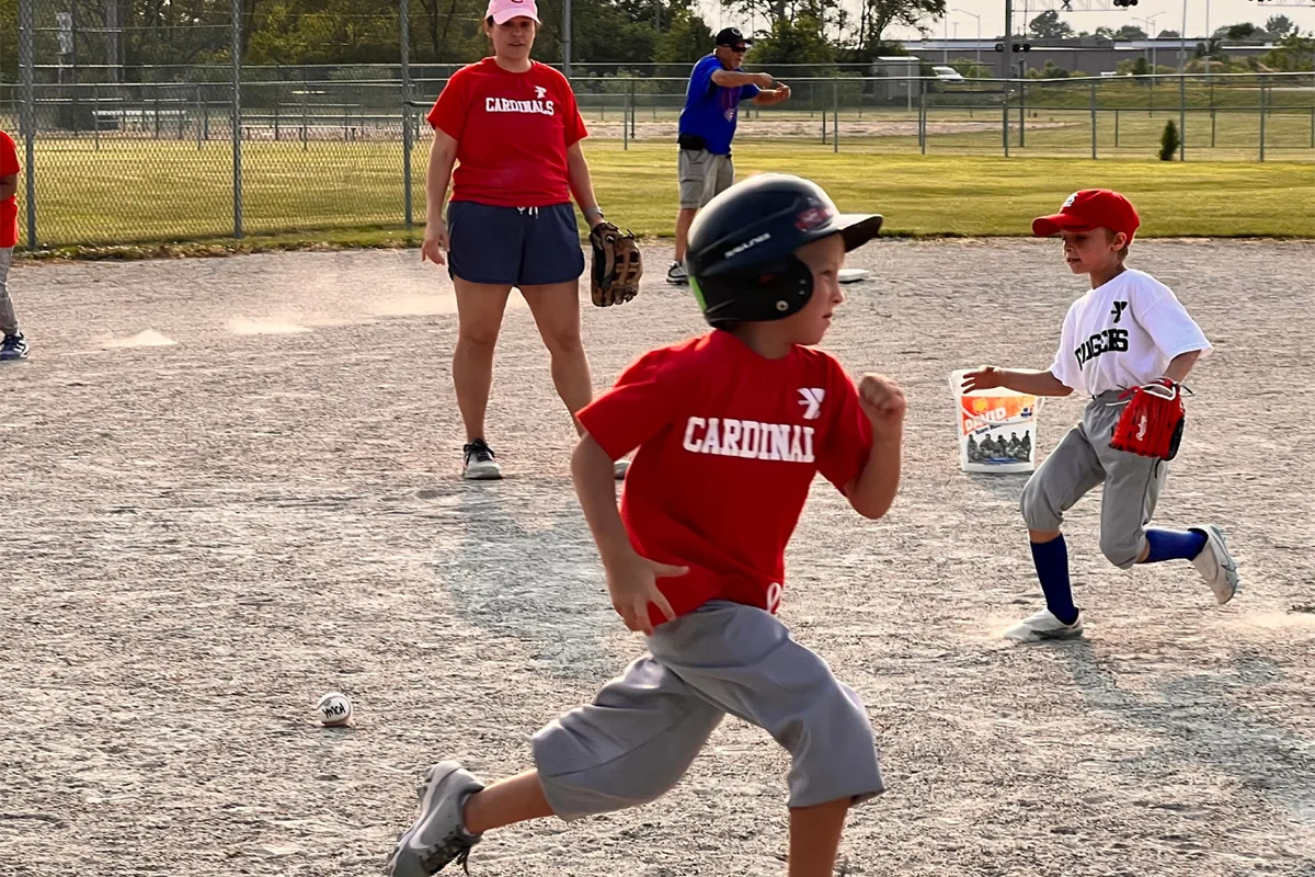 Youth participating in a baseball game at Springfield YMCA, focusing on skill-building and teamwork.