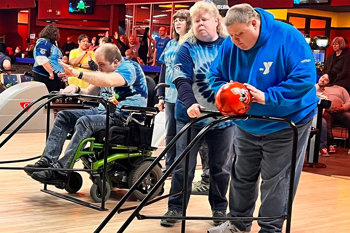 Individuals with diverse abilities enjoying a bowling activity, fostering inclusion and community with Springfield YMCA.