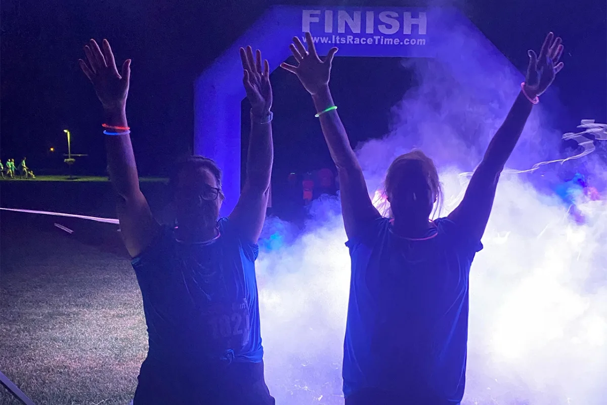 Participants in a glow-in-the-dark run organized by Springfield YMCA, emphasizing fun and fitness in a unique nighttime event.