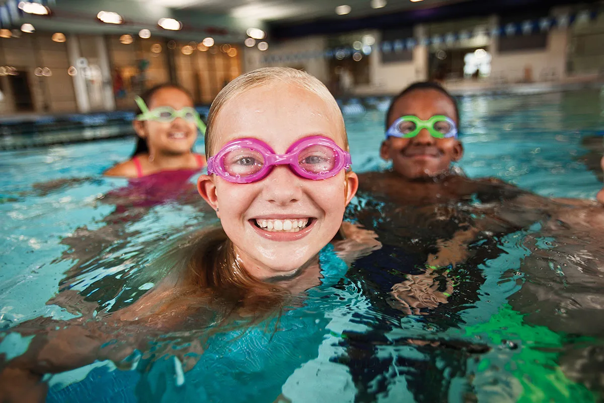 Young children during swim lessons at Springfield YMCA, demonstrating swimming proficiency and confidence.