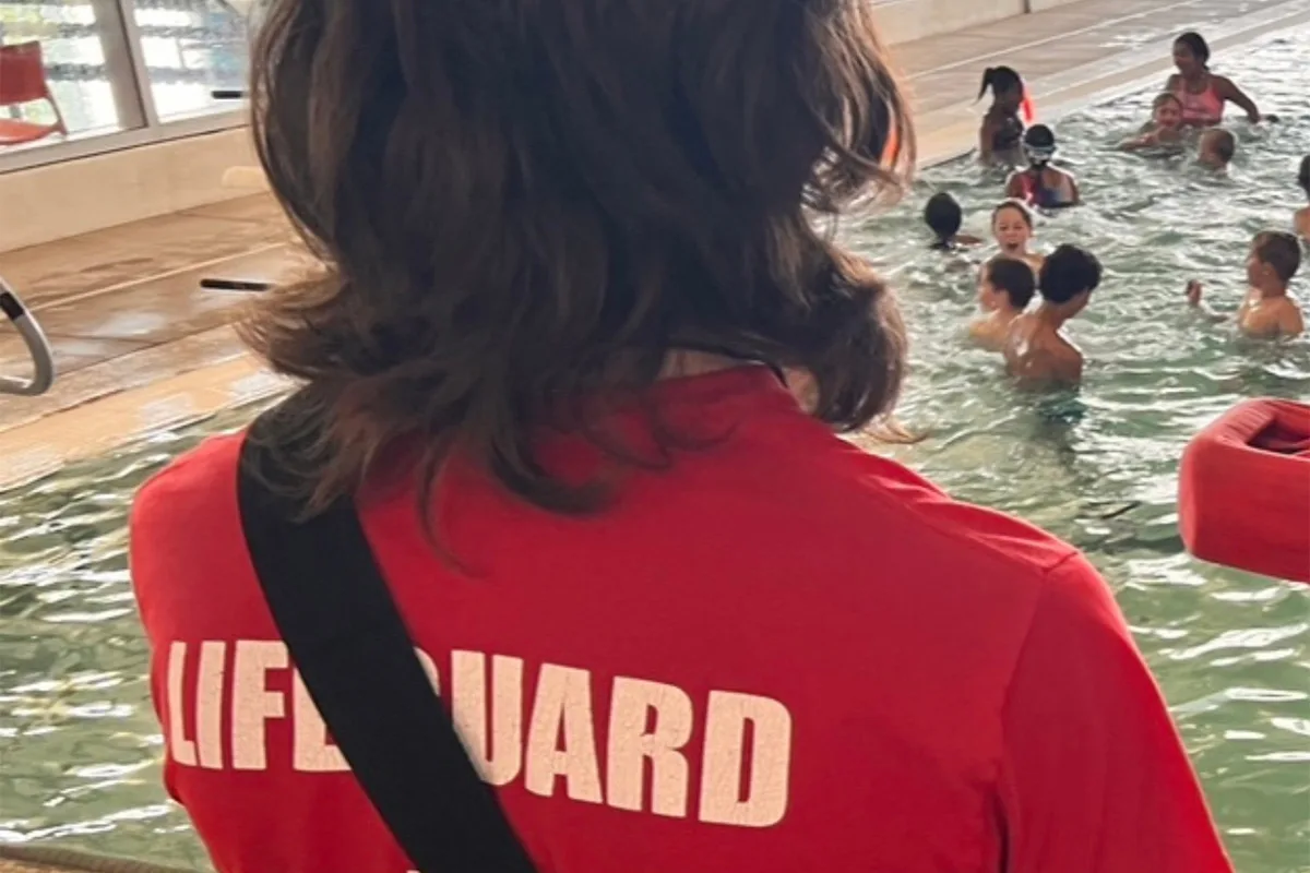 Springfield YMCA lifeguard watching over the pool, ensuring safety during swim lessons and recreational swimming.