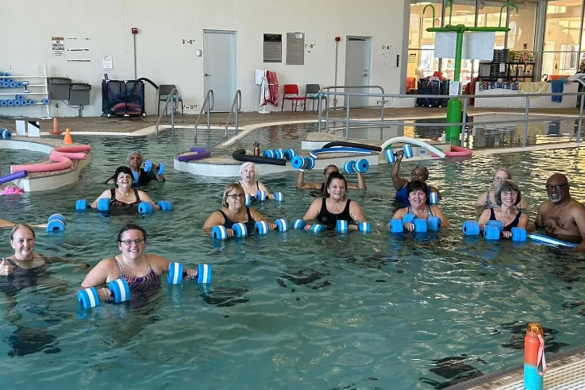 Adults participating in swim lessons at Springfield YMCA, improving swimming skills and fitness in a supportive environment.